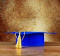 Graduation mortarboard on wooden table