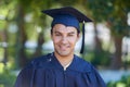 Graduation, portrait and man with smile to celebrate success, education and college scholarship outdoor. Happy