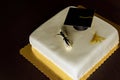 Graduation cake with cap on the top and diploma decor
