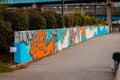 Graffiti art being painted on a retaining wall during Artprize