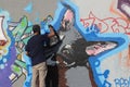 Graffiti artist painting on Berlin wall at Mauerpark