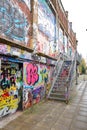 Graffiti brick wall art scale alley in germany Royalty Free Stock Photo