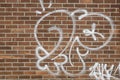 Graffiti on a brown brick wall Royalty Free Stock Photo