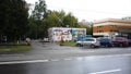 Graffiti on the building and standing cars on the road