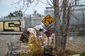 A graffiti covered End sign is adjacent to a homeless camp, trash, and train cars at 8100 Haskell Ave Royalty Free Stock Photo