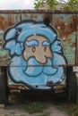 Graffiti depicting Santa Claus on a rusty truck