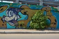 A graffiti with dog face and foliage