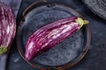 `Graffiti Eggplant`, a teardrop shaped variation with striped with violet with ivory white skin on iron tray