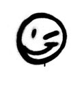 Graffiti emoticon wink face sprayed in black on white