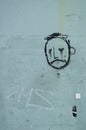 Graffiti, face of a sad looking man on a wall