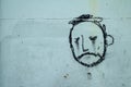 Graffiti, face of a sad looking man on a wall