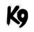 Graffiti K9 abbreviation sprayed in black over white