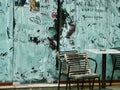 Graffiti on Metal Doors and Old Cafe Chairs and Table