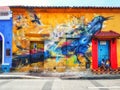 Graffiti mural of a bird on a house on Holy Trinity square Plaza Trinidad in the Getsemani neighborhood of Cartagena, Colombia