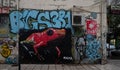 Graffiti mural with writing and dramatic red and green frog in Thessaloniki