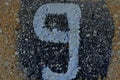 Graffiti of a number 9 on a wall