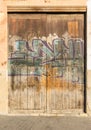 Graffiti paint on rustic old wood door gate Royalty Free Stock Photo