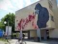 Graffiti of a building with a boy and hummingbird to Berlin in Germany.