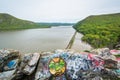 Graffiti on rocks and view of the Hudson River, at Storm King State Park, New York