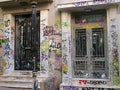Graffiti scribbled across two doors in Athens, Greece Royalty Free Stock Photo