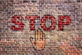 Graffiti stop letters hand brick wall
