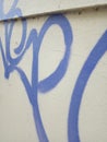 Graffiti street art up close on plain white wall blue artistic