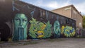 Graffiti style street art with surrealistic self-portraits by Hatziel Flores and Jeremy Biggers on Fabrication Street in Dallas. Royalty Free Stock Photo