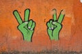 Wall with two symbolic hands doing the peace sign, standing in for peace