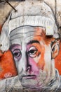 Graffiti on wall portraiting an italian famous actor wearing a white cap