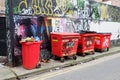 Graffiti Wall and Wheelie Rubbish Bins Royalty Free Stock Photo