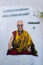 Graffiti on white wall representing the Dalai Lama