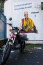 Graffiti on white wall representing the Dalai Lama