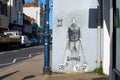 Graffiti in Whitstable by street artist Catman that depicts Queen Elizabeth II with her corgis