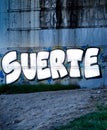 Graffiti with the word luck in spanish, Suerte, on concrete wall Royalty Free Stock Photo