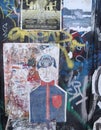 A Graffitied Wall with Lots of Tags and a Cartoon Faceless Man in a Blue Shirt