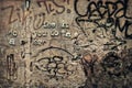 Graffitis and letters in relief on ruined wall Royalty Free Stock Photo