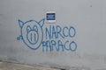 A graffitti protest art over a white wall of a bank in middle of colombian marches against National Government Royalty Free Stock Photo