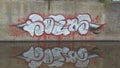 Graffitti writing on wall of concrete
