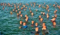 Competitors waiting in water to start swimming stage of triathlon,