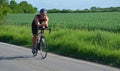 Close up of Male triathlete competitor on road cycling stage.