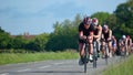 Triathletes on road cycling stage of triathlon. Royalty Free Stock Photo