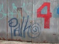 Grafitti on a metal wall with 4 painted Royalty Free Stock Photo