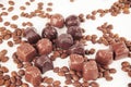 Grain black coffee and chocolate candy on a white background Royalty Free Stock Photo