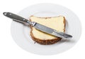 Grain bread and butter with table knife on plate Royalty Free Stock Photo