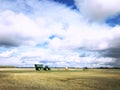 Grain cart and tractor in a rural countryside