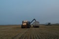 Grain cart unloading grain into a semi truck Royalty Free Stock Photo