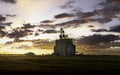 A grain elevator on the Canadian Prairies at sunset Royalty Free Stock Photo