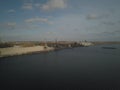 Grain elevator in the port on the river bank. Huge stainless steel tanks for storing crops. Aerial drone or quadrocopter aerial Royalty Free Stock Photo