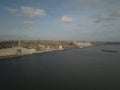 Grain elevator in the port on the river bank. Huge stainless steel tanks for storing crops. Aerial drone or quadrocopter aerial Royalty Free Stock Photo