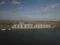 Grain elevator in the port on the river bank. Huge stainless steel tanks for storing crops. Aerial drone or quadrocopter aerial Royalty Free Stock Photo